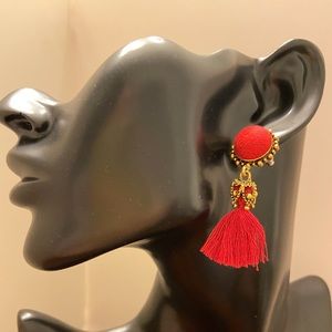 Red and gold pierced earrings with tassel